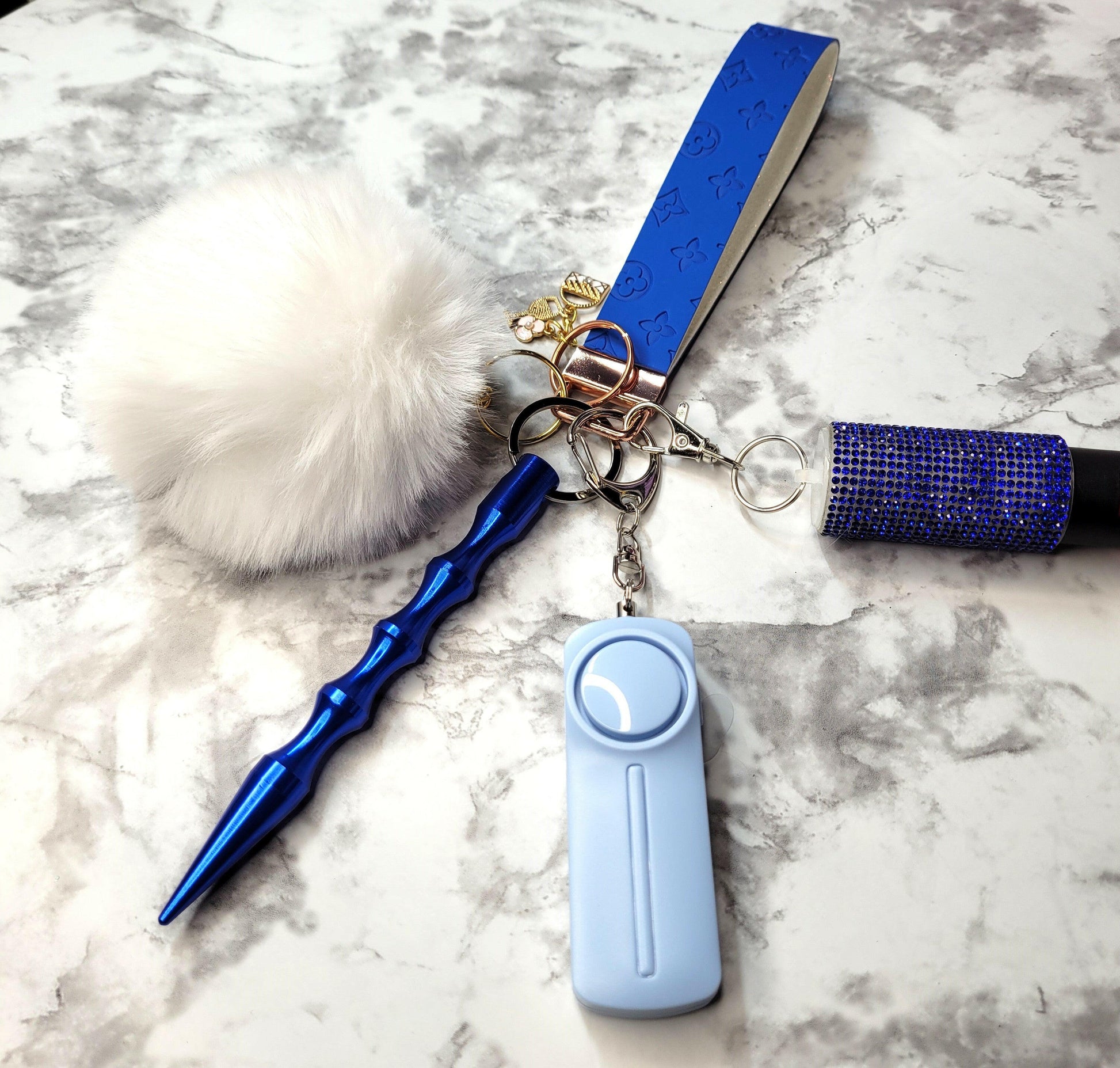 Blue Embossed White Pompom Faux Leather Self-Defense Keychain.