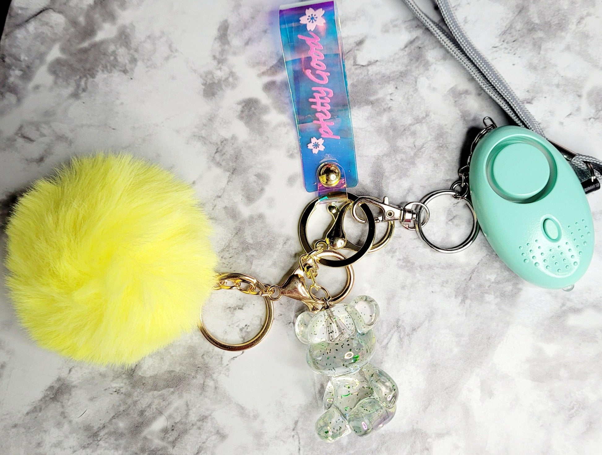 Iridescent Wristlet with Bear Yellow Pompom Keychain.